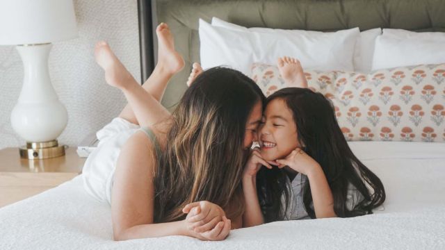 a woman and a girl on a bed